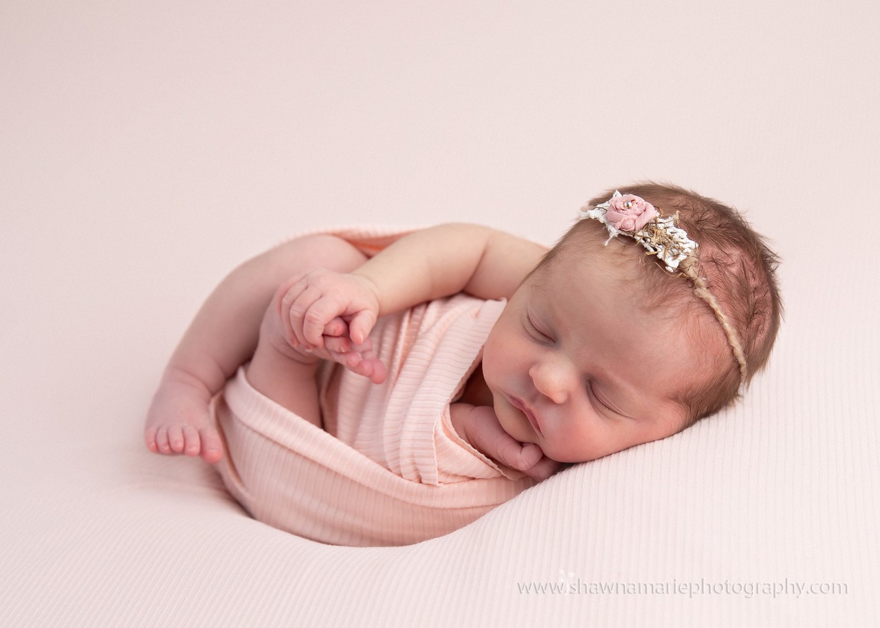 Newborn baby Alivia wrapped in pink with delicate headband - Greenfield Indiana newborn photographer